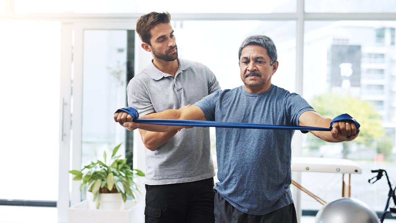 Physical therapist providing one-on-one care to adult patient during a personalized treatment session at Origin Rehab in Mint Hill.